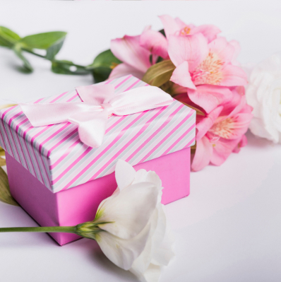 Gift box alongside various flowers